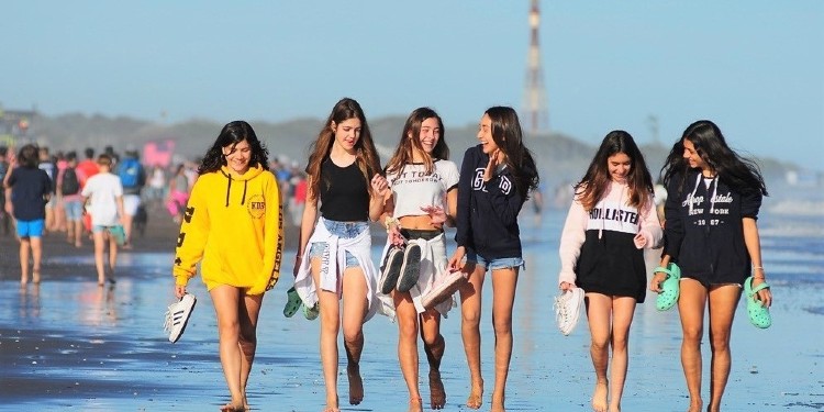Adolescentes caminando por la playa